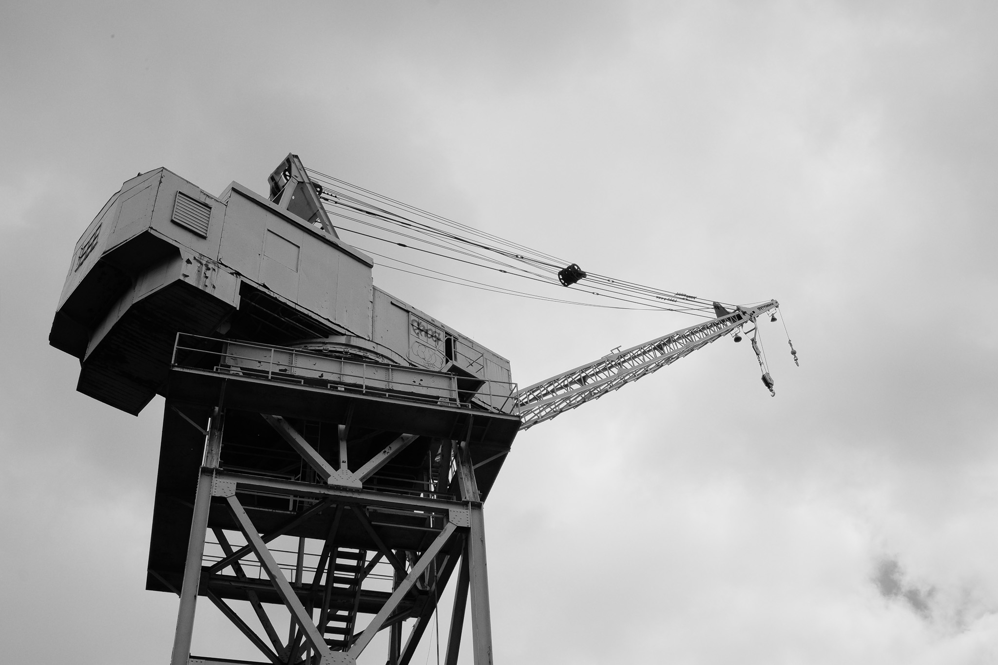 An abandoned crane shot against a cloudy sky