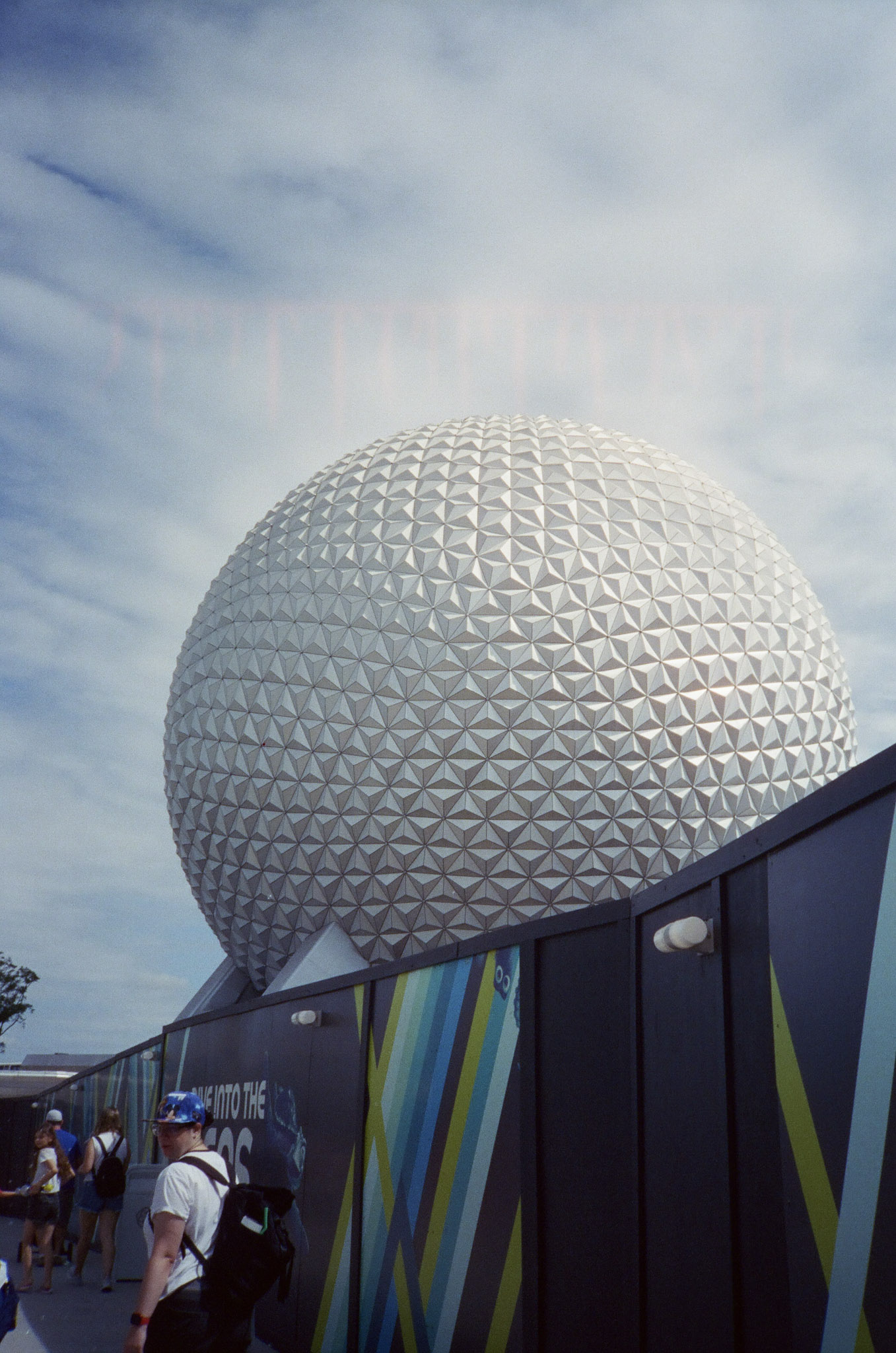 The Epcot Ball seen towering behind some wood construction walls