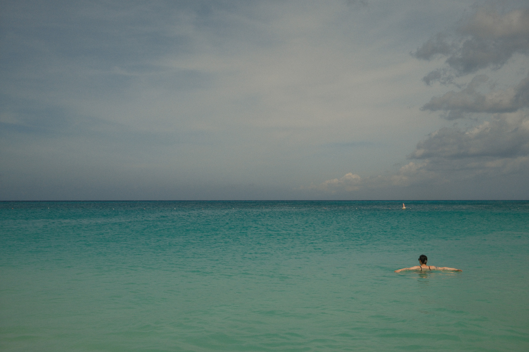 A woman floating in the shallow water.