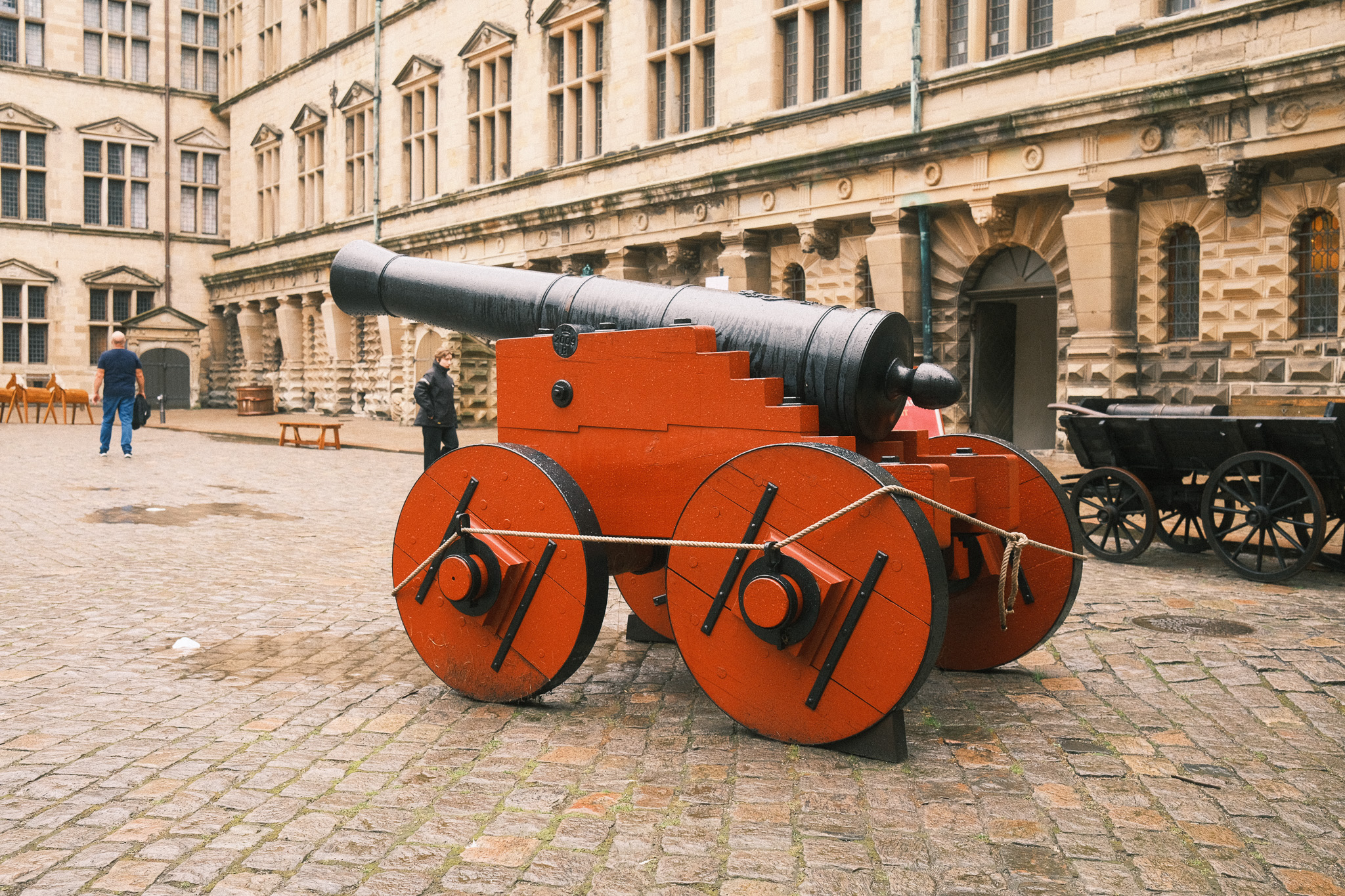A red cannon with a black barrel.