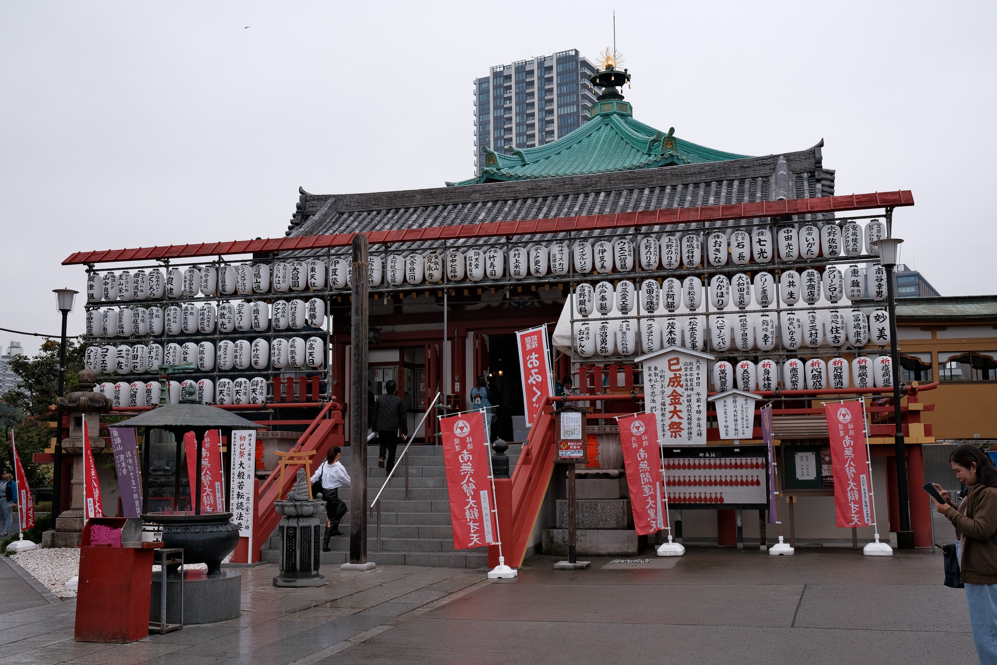 A temple in Tokyo with lots of lanterns in front of it.