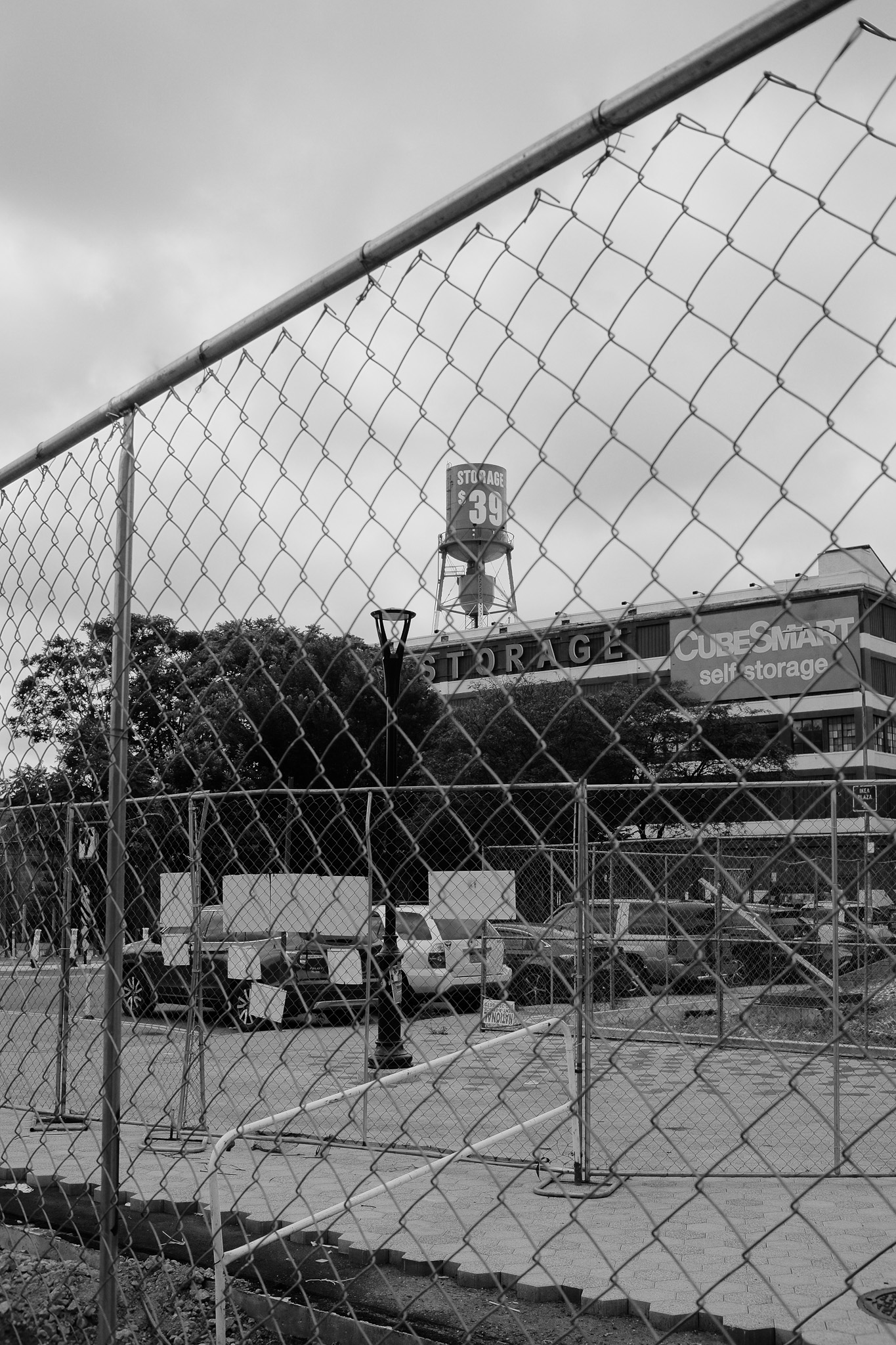 A shot of a cubesmart building from behind a chain link fence