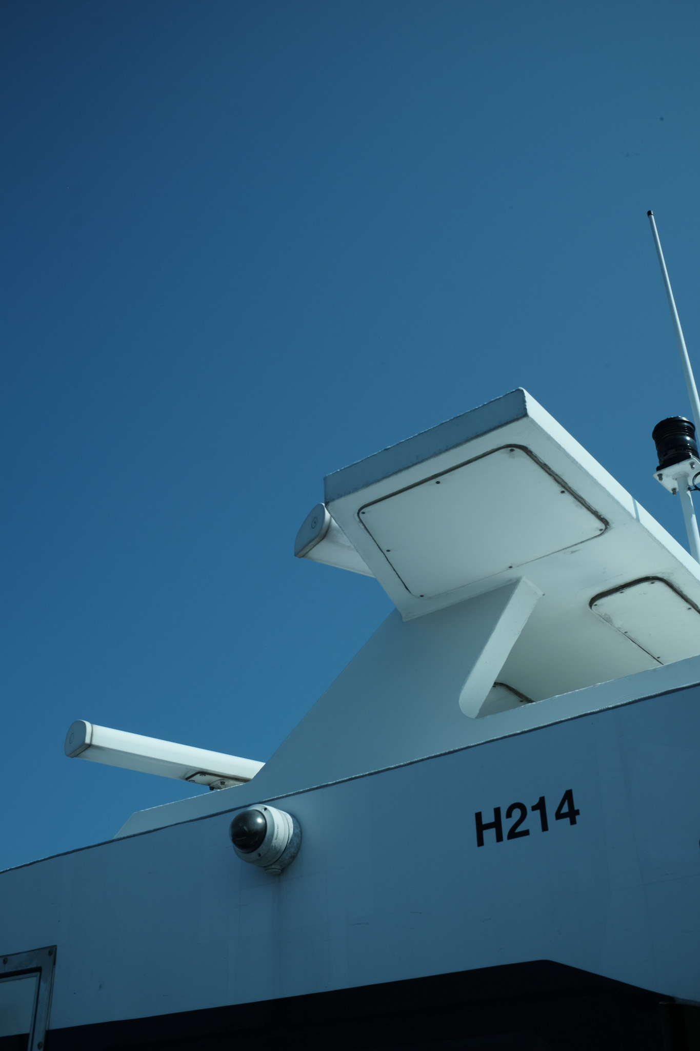 The antenna cluster of a NYC Ferry against a blue sky.