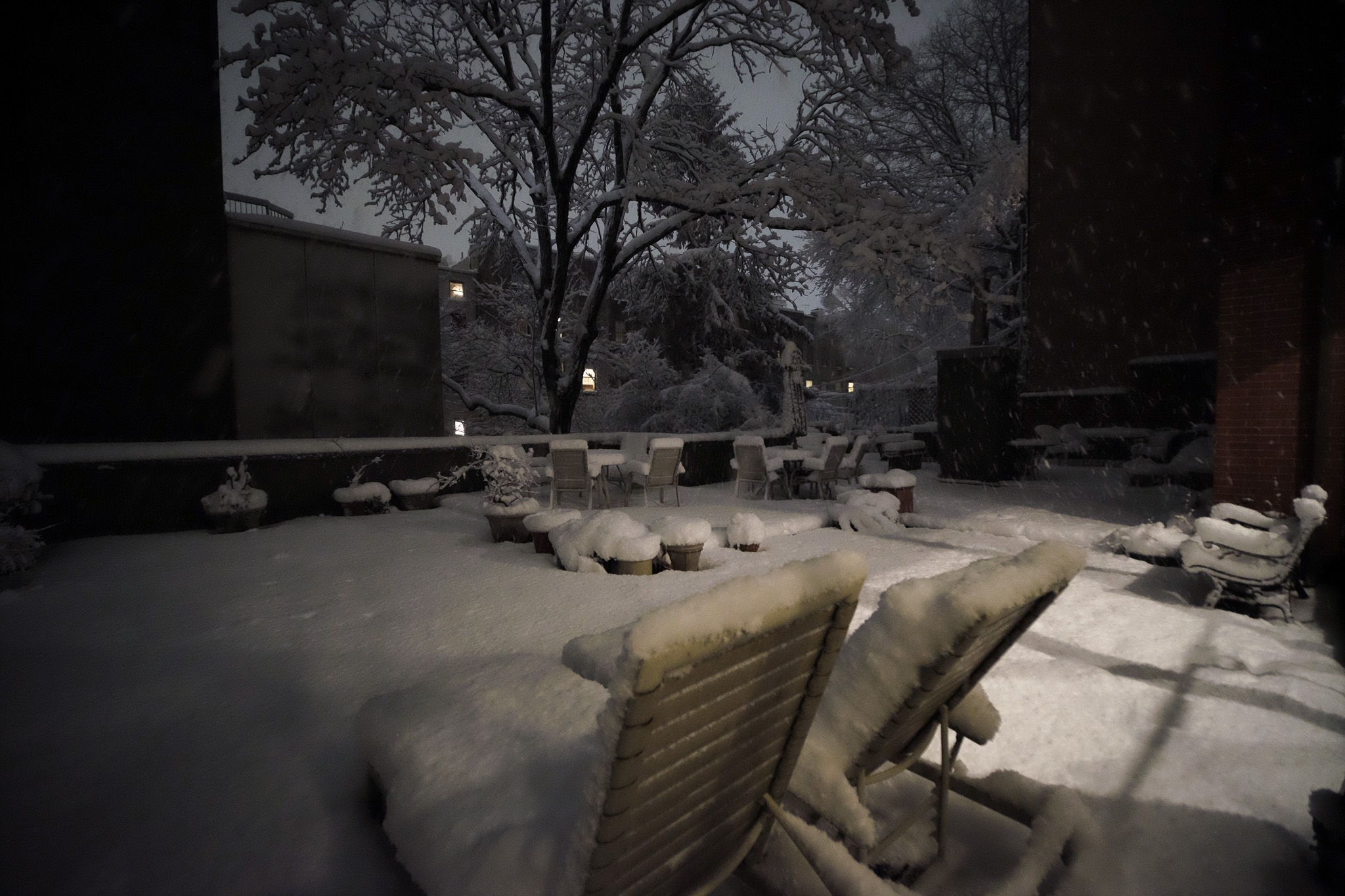 A deck covered in snow up to about a foot deep.