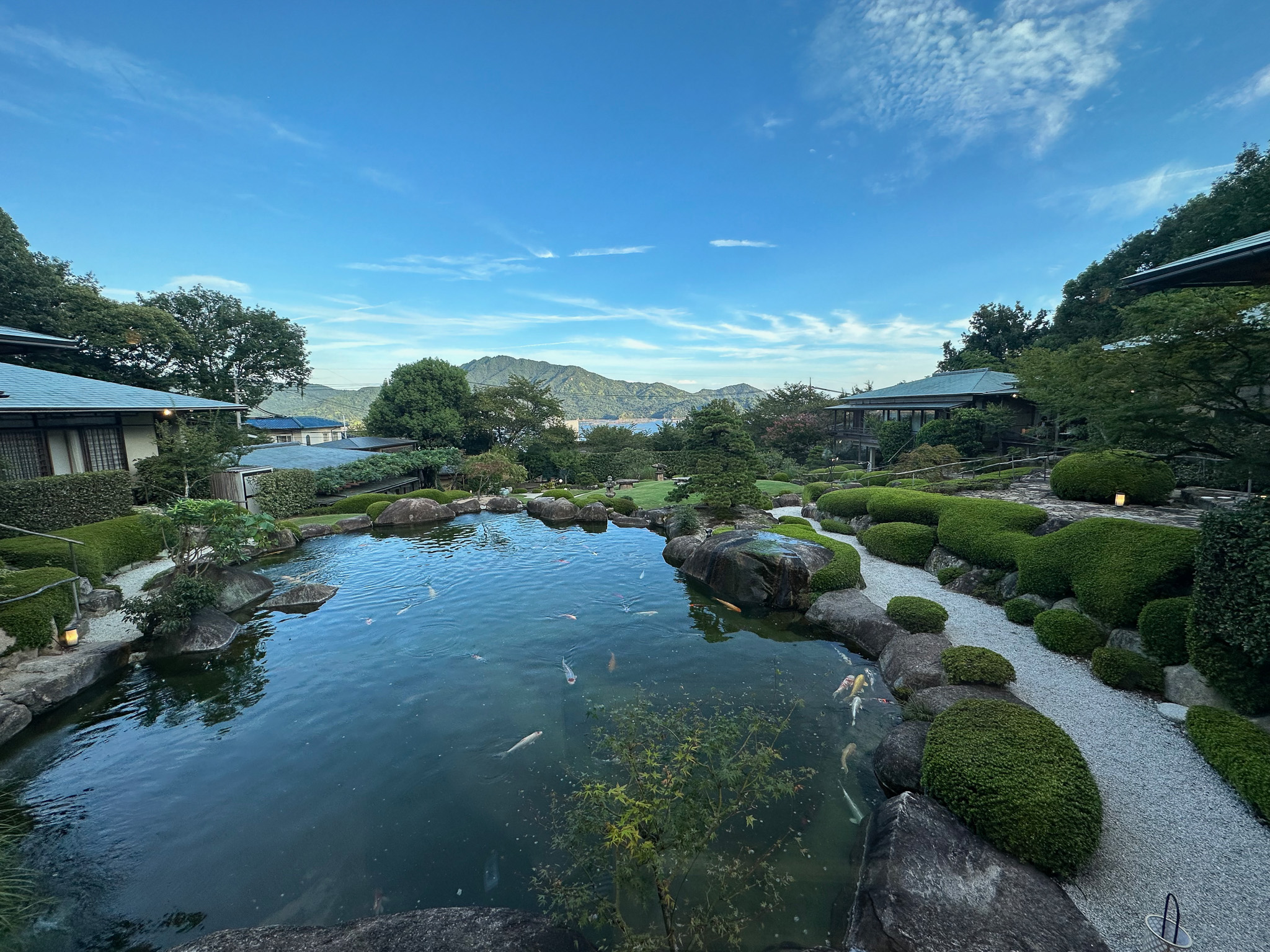 A koi pond in the center of low Japanese houses.